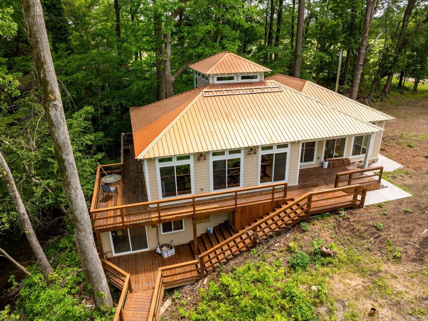 NEW CONSTRUCTION on the Little Red River! This fantastic cabin, built in 2024, includes 4 bedrooms and 4.5 baths, lots of glass, 3 bedrooms in the main house and a walk-out-basement full bedroom suite! House and optional river lot next door = $699,000. There's a new bridge to island behind the house! The views of Sugar Loaf Mountain are just outstanding! A must-see spot on the Little Red! ((Taxes not yet determined...new construction.))