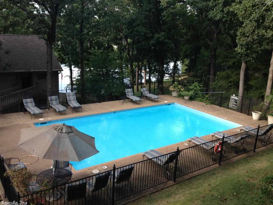 You'll feel right at home in this tastefully furnished and updated walk in level 2/2 condo overlooking a sparkling pool, large trees and a view of Lake Hamilton.  With a covered boat slip, tennis courts, and great location, the Sunset Cove 32 unit complex makes for easy living! Very well maintained grounds and landscaping.  Average elec. is $50 mo.  There is plenty of guest parking too.  Goat Island provides easy access and calm waters for your boat.