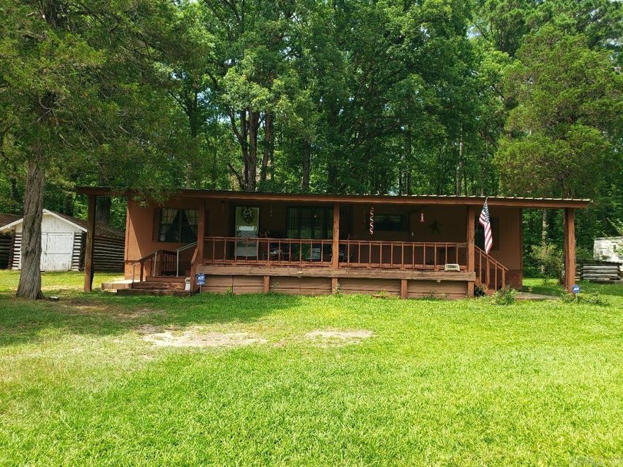 Fountain Lake School District. Home & 5 acres. 3 bedrooms 2 bath split floor plan with open concept. Vaulted ceiling in the living room. Dining with built in hutch. Roomy kitchen with pantry. Spacious Primary with ensuite and walk in closet. Secondary bedrooms share a hall bath with walk in shower. Laundry space with pantry & room for freezer. Big covered front porch for entertaining, storage bldgs. new driveway has 2 car carport. Over 200' of highway frontage. Large concrete patio space in the mostly wooded back yard. Wired for Security; will require new service by buyer. Propane tank leased Ferrell Gas. Newer Septic and HVAC. Appliances convey with acceptable offer. Offered AS IS WHERE IS. MUST BE PRE-QUALIFIED/PROOF OF FUNDS.