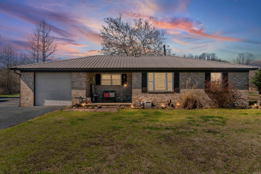 If you’ve been dreaming of peaceful country living with room to spread out, this property delivers. Nestled on 8 beautiful, fenced acres outside the city limits, you’ll find the kind of space that’s getting harder and harder to find. The brick home welcomes you with a warm, comfortable feel the moment you walk in. Inside you’ll find a charming kitchen, a cozy den perfect for slow mornings, original hardwood floors, dining area for family dinners, and a separate living area that gives everyone room to gather, host family, or simply unwind. The home also includes a laundry area and a layout that feels both functional and inviting. Step outside and enjoy the simple things — coffee on the porch and fresh country air. There’s a fenced area for pets or kids to play, along with a garage, carport, RV carport, pond, barn, feed shed with electric, and an RV hookup. One of the standout features is the massive shop, giving you endless possibilities for projects, storage, equipment, or hobbies. Plant your garden & enjoy the country while being 15 short minutes to town! And if you’re looking for extra income or space for family, the property also includes two mobile homes - AGENTS, SEE REMARKS