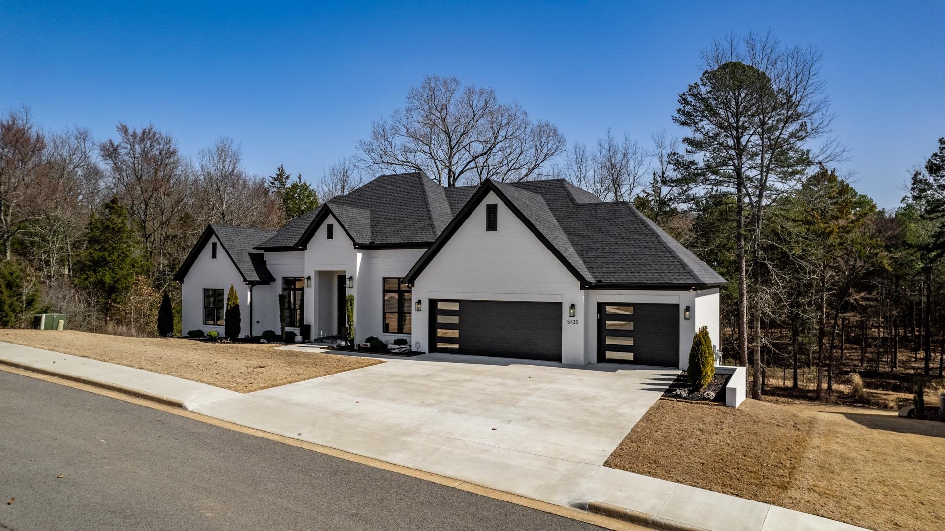 BEAUTIFUL CUSTOM BRIDGBILT HOME! 9-11ft ceilings on main level with 3 bedrooms, 2 bath. 1 bedroom 1 bathroom down. Main level has an 8 station linear fireplace! The master closet can open to the laundry room. The downstairs has a bedroom, bath, game room and den with 9 ft. ceilings. There is 1268 sf. of garage spaces, porches and storage. The back yard is mostly flat and wooded -check out fall pics! With $122/s average electric bill, you will appreciate the foam insulation, heat pump and gas furnace, one up and one down. Windows are Low E argon gas with 8' in 2 rooms in front and 7' in back living/dining.