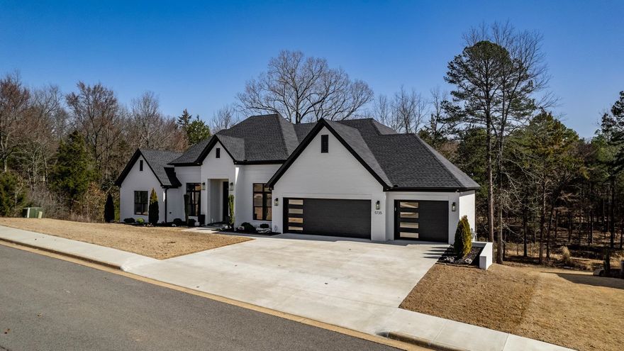 BEAUTIFUL CUSTOM BRIDGBILT HOME! 9-11ft ceilings on main level with 3 bedrooms, 2 bath. 1 bedroom 1 bathroom down. Main level has an 8 station linear fireplace! The master closet can open to the laundry room. The downstairs has a bedroom, bath, game room and den with 9 ft. ceilings.  There is 1268 sf. of garage spaces, porches and storage. The back yard is mostly flat and wooded -check out fall pics! With $122/s average electric bill, you will appreciate the foam insulation, heat pump and gas furnace, one up and one down. Windows are Low E argon gas with 8' in 2 rooms in front and 7' in back living/dining.