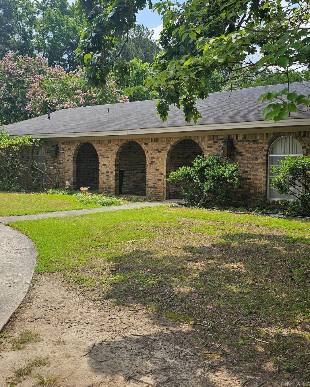 Boasting approximately 2,628 square feet of living space, this home features both a cozy den and a separate living room complete with a fireplace and soaring cathedral ceiling. You'll appreciate the walk-in closets and the convenience of a dedicated laundry area. Situated on over 1.5 acres, the property offers ample outdoor space ideal for entertaining, along with two storage buildings perfect for tools and yard equipment. A spacious circular driveway adds ease and functionality to the front of the home. Originally built in 1970, the house will require some updating, routine maintenance, and repairs. It is being sold as-is. Don't miss this opportunity—schedule your appointment today!