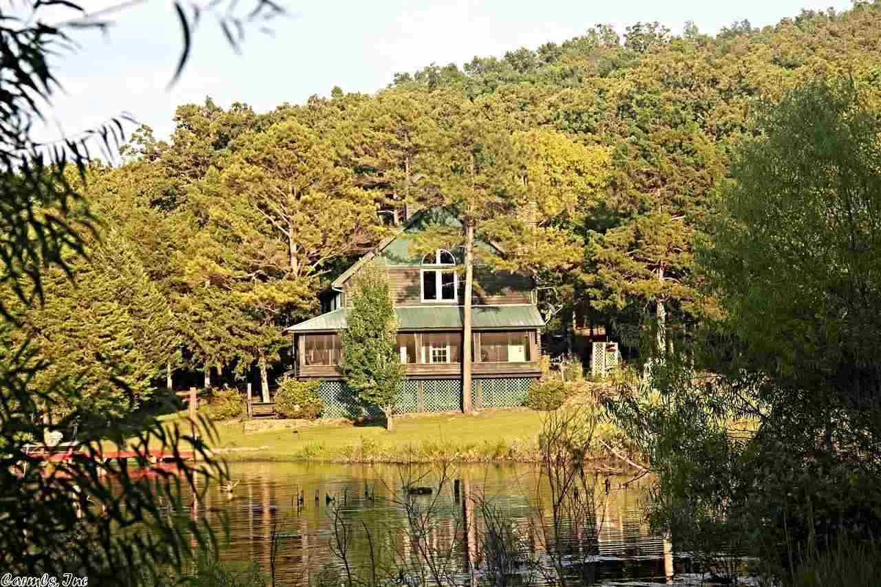 Custom Timber Frame home on 155 Acres. B&B or lodge potential. Main home features floor to ceiling stacked stone FP & Geothermal H/A. Guest house, Stand alone structure with great room and kitchen, custom built workshop & 2 pole barns. Quarter of a mile of highly sought after white river front with a private ramp and covered boat parking. Highly valuable bluffs, approx 20 acres in the Ranchettes subdivision and 50 acres of pasture. 9 acre stocked pond, deer and turkey on acreage. www.ozarkmountainhome.info