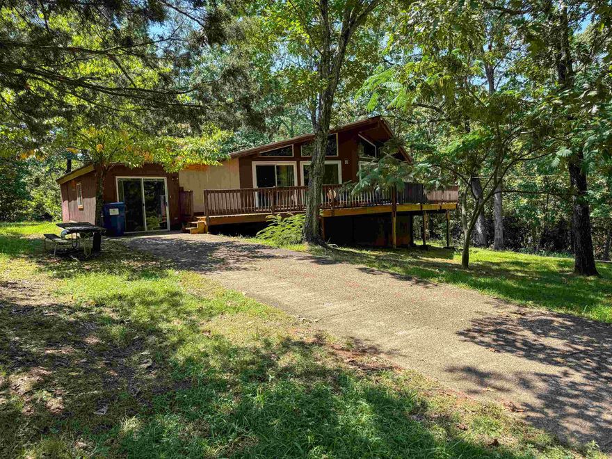 Welcome to the Ozarks!  This charming split-plan home, featuring 3 bedrooms and 2 baths, is nestled on two spacious lots in the highly sought-after community of Cherokee Village. Its vintage character truly sets it apart, offering a unique and timeless appeal. Located just minutes from the Spring River and several serene lakes, this home is perfect for nature lovers and those seeking a peaceful retreat.  Recent updates include a brand-new roof (installed just a year ago), fresh deck boards, new air conditioner, and a new gas water heater. Windows and doors were upgraded to double-panes around 2010.  Don't miss the chance to own this lovely piece of the Ozarks!