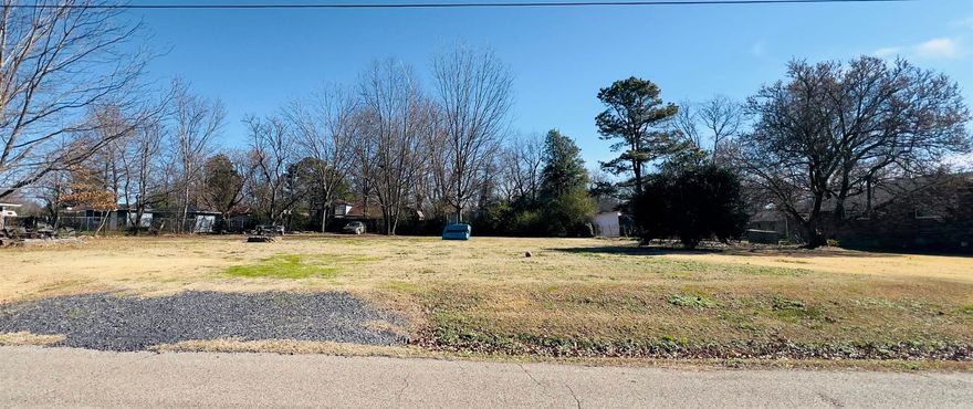 Beautiful large lot with easy access to Eve Street. RV hookup, water, 200 amp entrance on property. Sewer at street. Park like setting with Pecan and Maple trees. Wonderful location to build a home. Close to shopping, schools, medical facialties. Close to bike trails, Ward Lake, Ouachita Mountains.