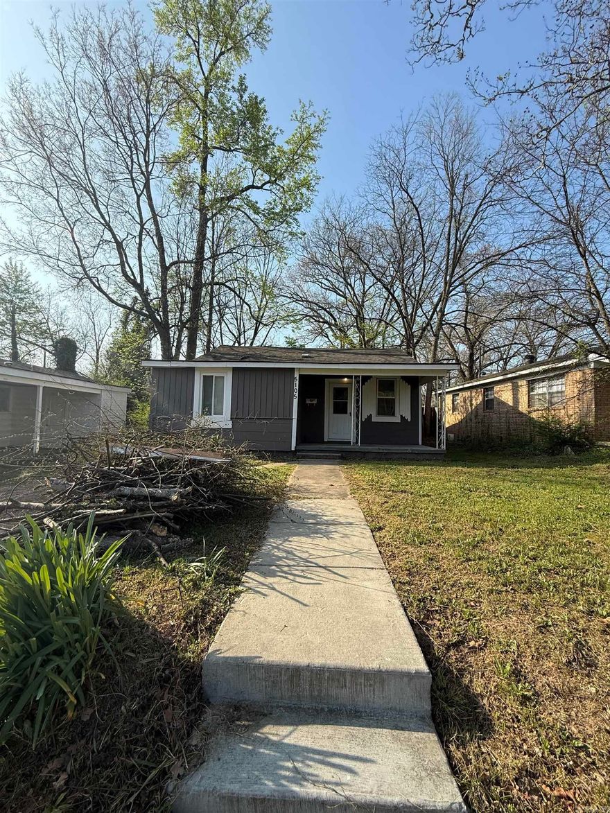 Character and convenience meet in this 2-bedroom, 1-bathroom traditional home located in the established Boulevard Terrace community. Spanning 1,036 square feet, the interior features classic hardwood and new flooring throughout, a cozy fireplace, and an eat-in kitchen designed for functional living. The property sits on a level 0.14-acre lot with a private patio, offering a manageable outdoor space for relaxation or entertainment. This residence is exceptionally well-placed for students and professionals, situated just down the street from the University of Arkansas at Little Rock (UALR).