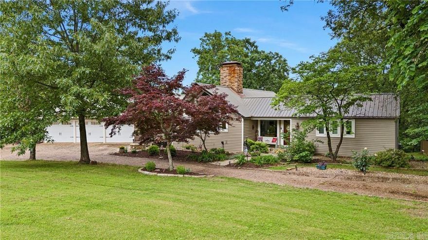 This pristine front yard sets the tone for your own private paradise. From the moment you step inside, the warmth and craftsmanship of this beautiful home are unmistakable. Floor-to-ceiling windows frame uninterrupted views, while soaring ceilings, exposed wood beams, and hardwood floors create an inviting, timeless atmosphere. The classic kitchen adds to the home’s enduring character, making every guest feel welcome.