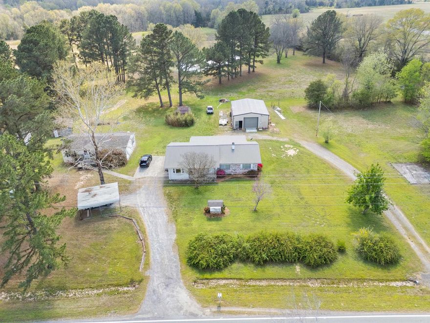 Welcome to 91 E Main St. This is a proeprty full of opportunity in a highly visible and convenient location right in the heart of town. Whether you are looking for a place to call home or a great investment with acreage and potential. This property is close to all kinds of ammenities. Also there is a shop with three phase and heaters! RV Hookup with 50 amp. There is a half bath in shop. 6 inches thick with rebar on each side. So if you are looking for opportunity here it is on a total of 7.44 acres! Call today and schedule a tour.