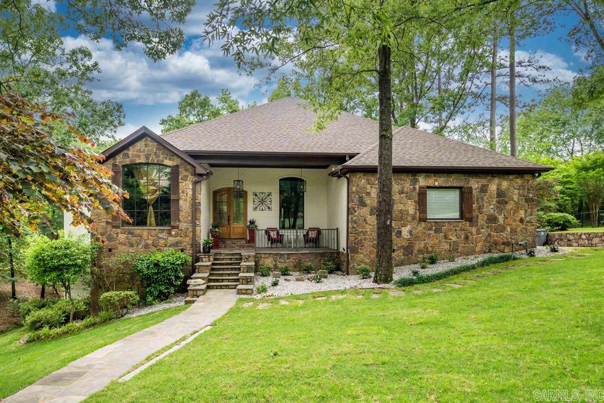 Fall in love with this custom built, four bedroom three & one-half bath home nestled in coveted Lotus Valley, renowned for its peaceful ambiance & natural aesthetic. This home harmonizes timeless elegance, modern updates & a connection with nature like no other. The main level boasts a thoughtfully designed open floorplan, ideal for both relaxation & entertaining. The living room adorned with a cozy stone fireplace, invites you to enjoy the picturesque views of the mature landscape. Adjacent to the living room, you'll find a gourmet kitchen that will delight even the most discerning chef. It features quality stainless appliances, custom cabinetry, granite counter tops along with a generously sized island perfect for meal preparation & casual dining. The adjoining dining areas provide seamless flow for hosting gatherings of any kind. There are two bedrooms on the entry level & two on the lower level. Each is well appointed with generously sized closets & bathrooms. You will not want for storage in this thoughtfully designed space as there is plenty on the lower level as well as a three-car oversized garage on the main floor. Outdoor enthusiasts will enjoy the two large, covered po