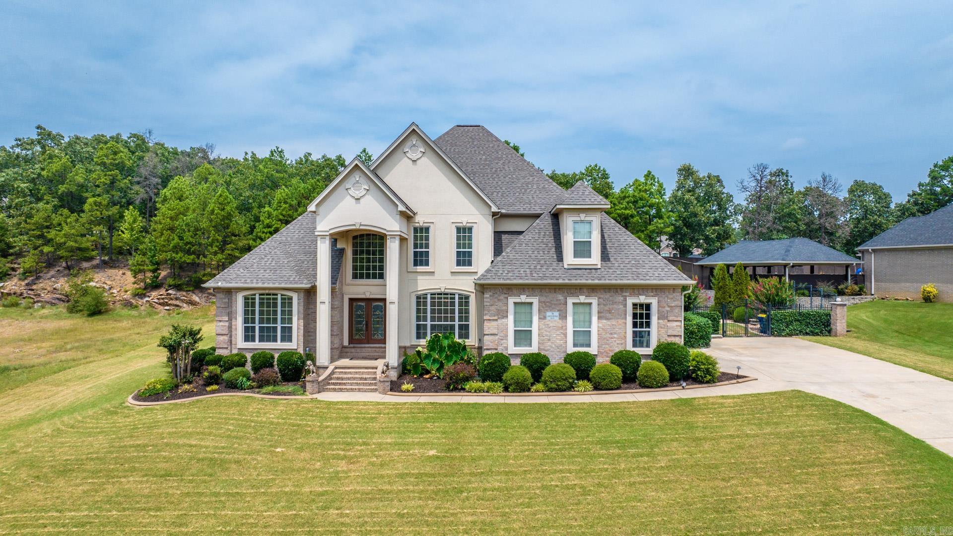 As you enter this beautiful home you are met with grand 20' ceilings, an office with custom built-ins, and a formal dining room. This 5 bedroom and 3.5 bath home features a master suite on the main level as well as additional bedroom with private ensuite on the main floor. Standing at the top of the staircase, a balcony overlooks the impressive living space with ambient natural lighting. You will enjoy a full bathroom and three additional bedrooms upstairs with one that could function as a bonus room space, if desired. Enjoy your backyard complete with tiered landscaping and inground swimming pool perfect for entertaining! Agents, please see confidential remarks.