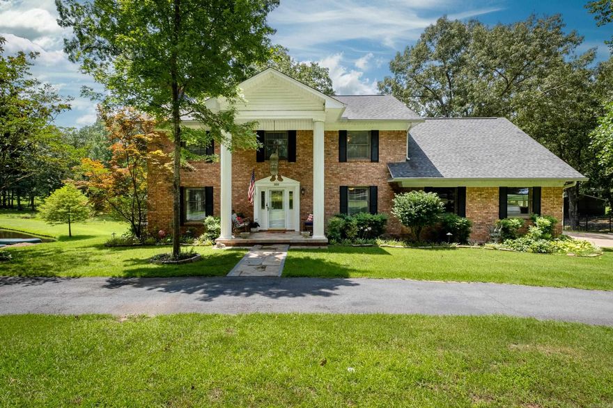 Rare, private retreat on 5 acres - complete with canoeing & fishing pond, dock, in-ground pool with slide, covered pergola, whole house generator and 2 storage buildings. One owner, brick, circular drive, 3 living areas, dual staircases, versatile floor plan. Renovations - tile floor, kitchen - granite, subzero refrigerator, stainless appliances, island, cabinets, tongue and groove wood ceiling. Handy office and mud room off kitchen/garage. Tile shower, Jacuzzi shower and tub, connecting laundry to master. Large game room/bonus room up. Peaceful paradise!