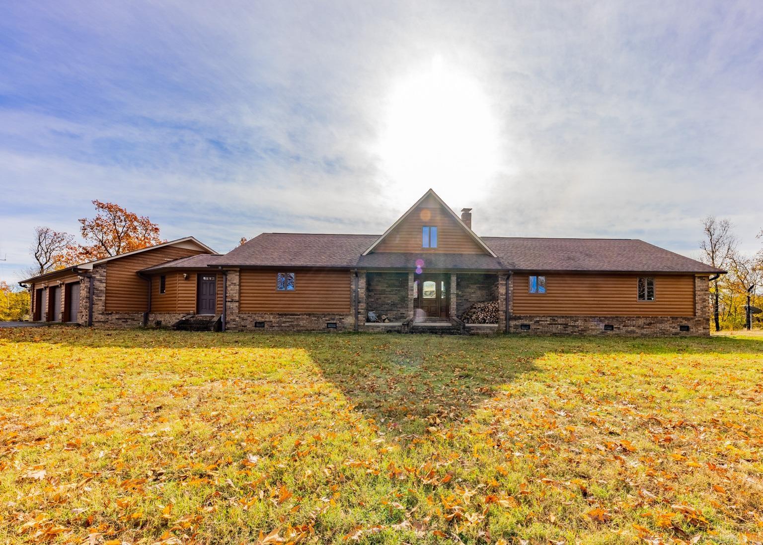 INCREDIBLE VIEWS from your own private sanctuary sitting hilltop on 50 acres, surrounded by National Forest. Walk in the the front door to a wall of windows overlooking farmland and mountains. Large deck spanning the back of the home. Home has 2 spacious bedrooms downstairs and a Loft upstairs, which can be used as a 3rd bedroom, office, etc. Upstairs loft overlooks the family room, as well as, directly across from the windows for an even better view. Spacious open kitchen with an island, breakfast bar & tons of cabinetry. Huge laundry room with even more storage, connecting to the mud room from the 3-car garage. Amazing woodburning fireplace that has i't's own ductwork, keeping the entire home nice & warm. Includes a generator. Tree-lined drive to home with it's own private gate.