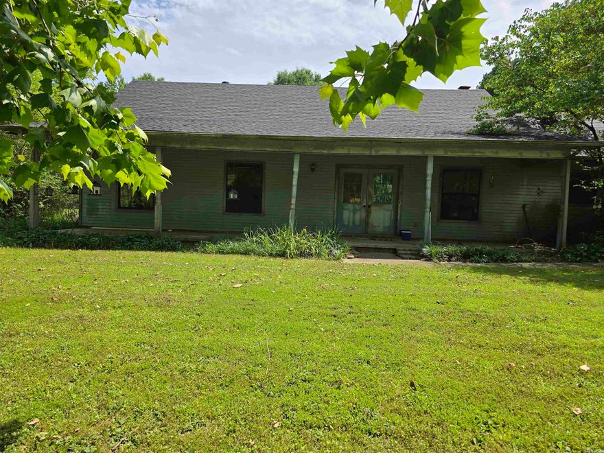 Looking for a Great Investment? This is the property for you!! The home is in need of some TLC like new paint, flooring, kitchen cabinet doors and some outside work but has some beautiful features like the large covered front porch, the vaulted living room ceiling with wood beams, the wood burning fireplace and the spacious 1.5 acre lot. It also has a new roof, water heater and the inside of the garage has been completley redone and both the heat and air units were replaced 3 years ago and have a manufactures warranty until 2032. House is being sold as is.