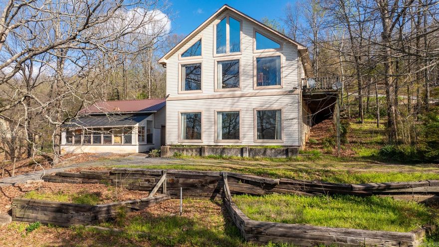 Enjoy country living just a short drive from town here on peaceful Eagle Crest Drive. Tucked in the trees, on a large 1.21 acre corner lot, you'll find this architecturally unique home. A large porch to the front door gives you great views. The open concept living dining is flooded with natural light through the large windows and features a peaked tongue-in-groove wood lined ceiling. The wide plank real hardwood throughout the main level is gorgeous. The upper level hosts your living/dining and primary bedroom suite. At the lower level you have a huge 2nd living space, a 2nd bedroom, and 2nd bathroom. This large space could also be framed out into more bedrooms or finished out with a kitchenette to create a mother-in-law quarters. This space features more large windows and also has its own private entrance. It can also function as it is, a large 2nd living space. Your corner lot has immense landscaping opportunities. Also on the property is a shop & greenhouse. This home is incredibly unique and full of possibilities. New roof 2023. Come and create your treetop oasis today!
