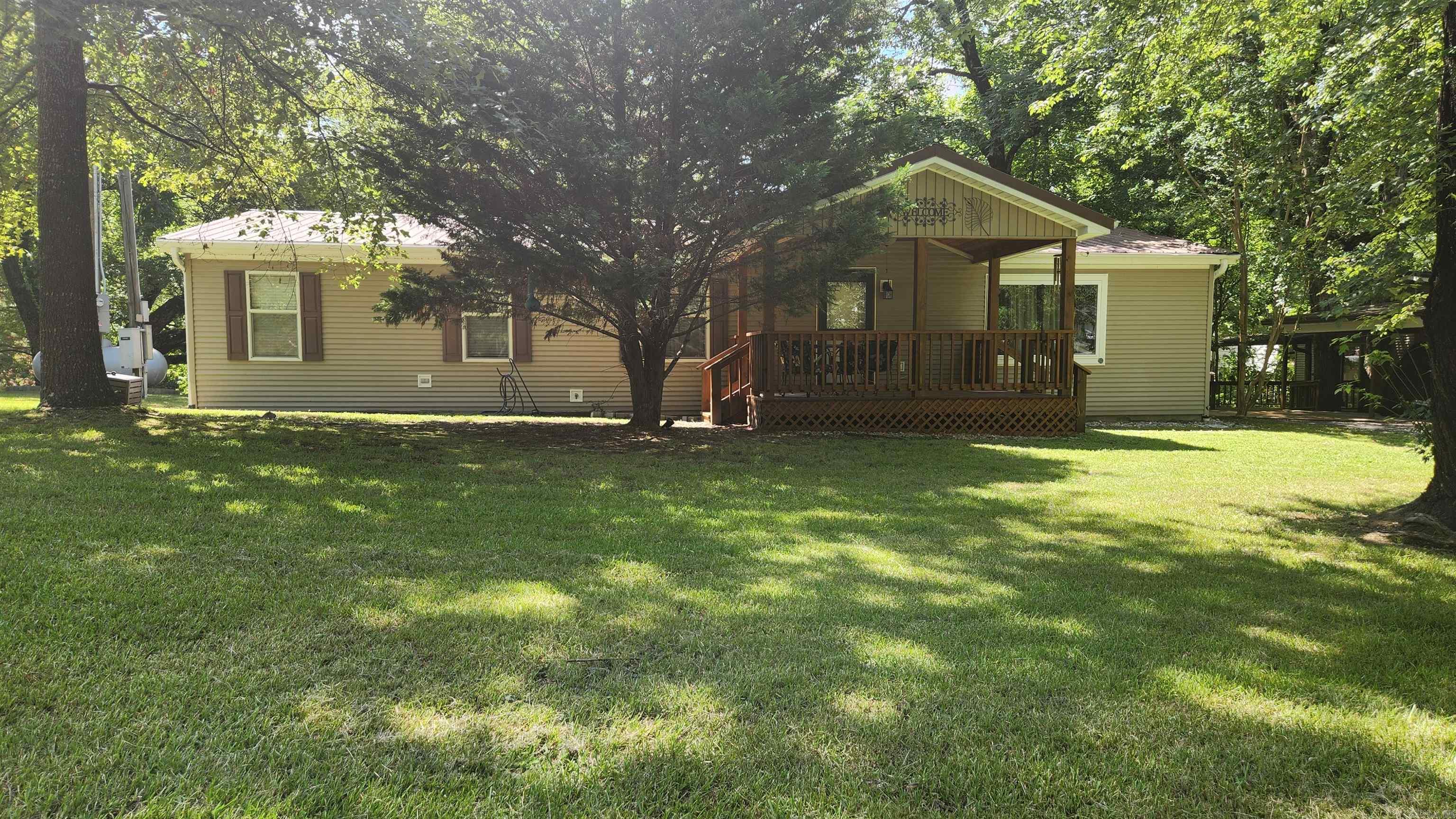 This is a "Dutch" built mobile in the Joplin Trailer Park. Features 3 bed, 2 bath, plus a bonus room (12x13) off the back deck. 1764 sq ft of indoor living space. 2 car carport (29x23), "Fish hut" 15x17 includes power, water, air and has a metal roof. 12x24 storage building. Concrete block basement YES there is a basement/storm shelter. 13x11 front porch and 41x14 covered back deck overlooking Gap Creek. 20 kw Generac generator. Let's talk about inside.....these are extra thick drywall walls. Kitchen has granite counter tops. Both bathrooms have been upgraded. The home is furnished. Brand new fridge. Laminate flooring throughout. Super nice. Just minutes away from Lake Ouachita.