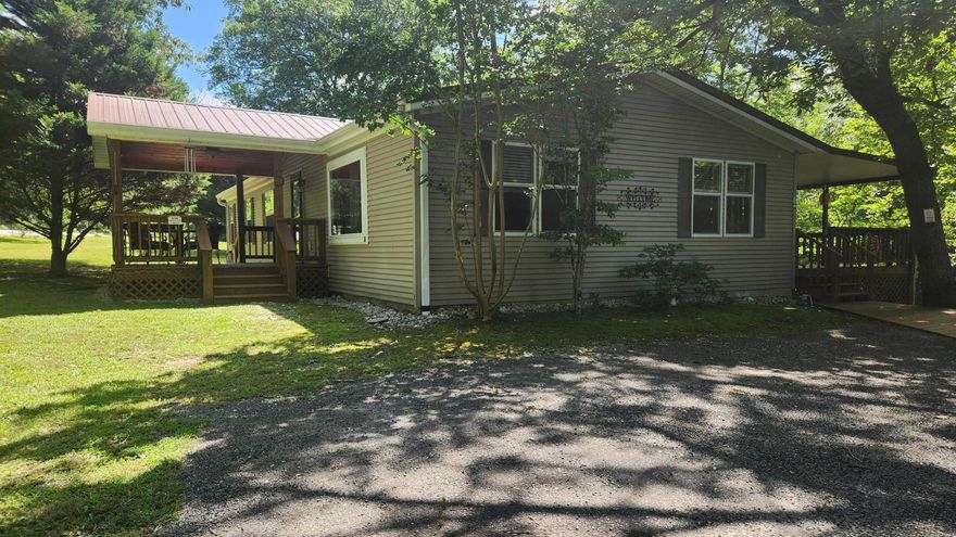 This is a "Dutch" built mobile in the Joplin Trailer Park. Features 3 bed, 2 bath, plus a bonus room (12x13) off the back deck. 1764 sq ft of indoor living space. 2 car carport (29x23), "Fish hut" 15x17 includes power, water, air and has a metal roof. 12x24 storage building. Concrete block basement YES there is a basement/storm shelter. 13x11 front porch and 41x14 covered back deck overlooking Gap Creek. 20 kw Generac generator.  Let's talk about inside.....these are extra thick drywall walls. Kitchen has granite counter tops. Both bathrooms have been upgraded. The home is furnished. Brand new fridge. Laminate flooring throughout. Super nice. Just minutes away from Lake Ouachita.
