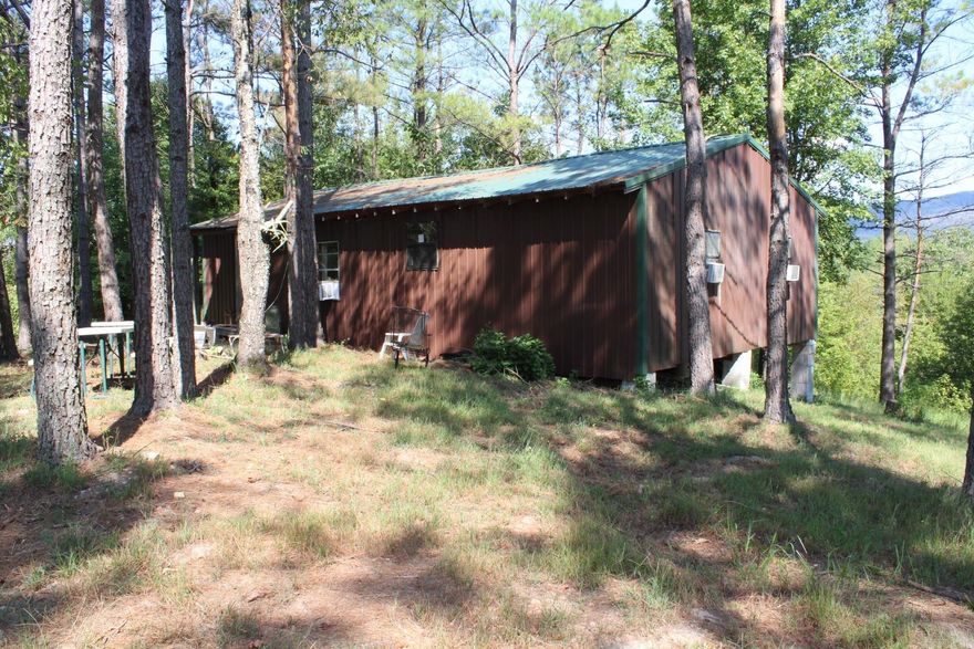 Cabin approx. 4 miles from Albert Pike Recreation  area with approx 1152 sq. ft. of living space features kitchen/dining/large living space combo.  3 bedroom, 1 bath .  12 x22 covered deck with beautiful views.  FURNITURE AND APPLIANCES CONVEY WITH SELL OF CABIN.