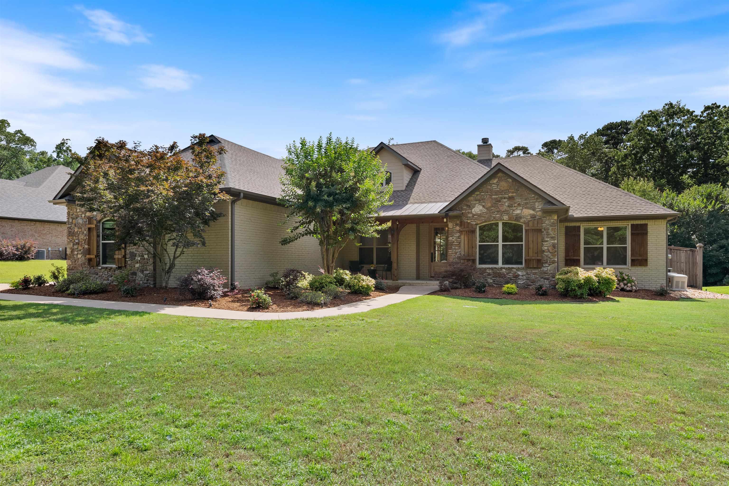 Tucked just outside the Little Rock city limits, this stunning home is a private retreat on nearly an acre close to West Little Rock's dining and shopping. Down a long driveway, the painted brick and Arkansas natural stone exterior creates striking curb appeal, complemented by a welcoming front porch. Inside, the open floor plan lives as a one-story home offering a formal dining room with coffered ceiling, a home office with French doors, and a spacious great room with stone fireplace, custom built-ins, and large windows that frame the backyard oasis. The gourmet kitchen includes a center island, granite counters, new backsplash and dishwasher, gas cooktop, wall oven, microwave, walk-in pantry, and breakfast room. The main-level primary suite features patio access, spa-like bath, and two walk-in closetsāone with a FEMA-rated safe room. A guest bedroom with private bath, two additional bedrooms with a shared bathroom, laundry room, and mud room complete the main level. Upstairs offers a 5th bedroom, game room, study nook, full bath, and walk-in attic. Enjoy a saltwater pool, spa, cabana, outdoor kitchen, and more!