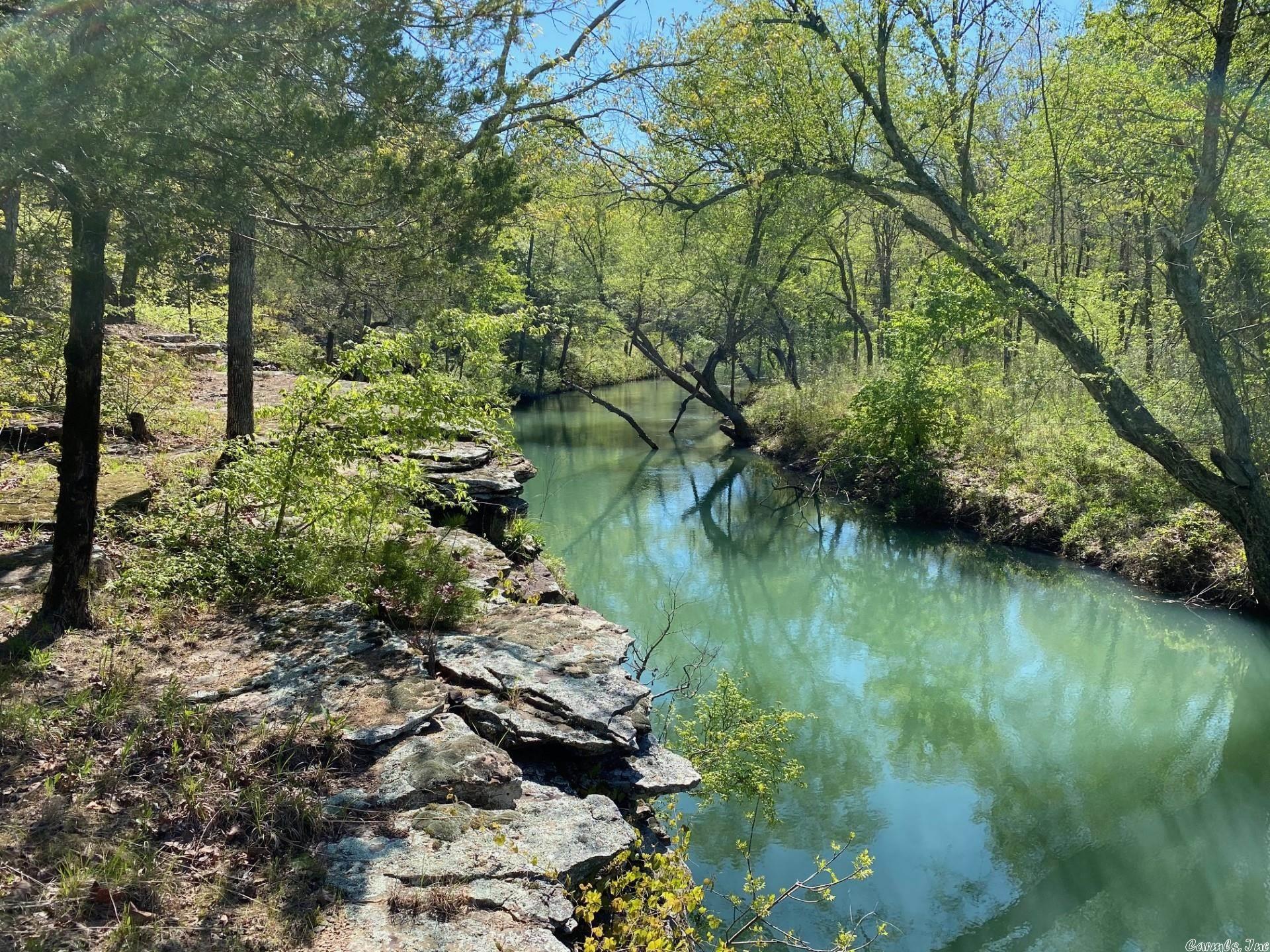 Beautiful flat and rolling acreage with a Searcy Address but just over the line into Cleburne County. Consists of both wooded and meadow areas. APPROXIMATELY 3.5 MILES OF 'BIG CREEK' (year round flowing creek) IS EITHER THE BORDER OF OR RUNNING THROUGH THE PROPERTY! Many scenic spots along the creek and from some bluffs above the creek. Prime hunting property (deer and turkey). Property also has a pond. There is approximately 30+/- acres of 15 year old planted Plantation Loblolly Pines (rule of thumb worth is $100 per acres per year of growth). MINERAL RIGHTS DO NOT CONVEY There are two access points to the property. One is through the lower 63 +/- acres, the other is a road easement further down Spring Road. See layouts in documents. The lower 63 +/- acres could be purchased separately leaving approx. 465 acres to be sold together. Otherwise, property must be purchased all together so as to not create areas with no access. Seller will only be providing an existing survey showing boundaries and corners. Most corners have findable markers. Buyer will be responsible for cost of any new survey. Property is approximately 30+/- miles from Searcy or Heber Springs. SEE REMARKS