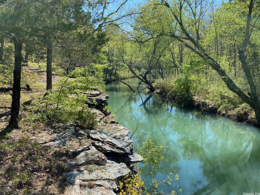 Beautiful flat and rolling acreage with a Searcy Address but just over the line into Cleburne County. Consists of both wooded and meadow areas.  APPROXIMATELY 3.5 MILES OF 'BIG CREEK' (year round flowing creek) IS EITHER THE BORDER OF OR RUNNING THROUGH THE PROPERTY!  Many scenic spots along the creek and from some bluffs above the creek.  Prime hunting property (deer and turkey).  Property also has a pond.  There is approximately 30+/- acres of 15 year old planted Plantation Loblolly Pines (rule of thumb worth is $100 per acres per year of growth).  MINERAL RIGHTS DO NOT CONVEY  There are two access points to the property. One is through the lower 63 +/- acres, the other is a road easement further down Spring Road.  See layouts in documents. The lower 63 +/- acres could be purchased separately leaving approx. 465 acres to be sold together.  Otherwise, property must be purchased all together so as to not create areas with no access. Seller will only be providing an existing survey showing boundaries and corners.  Most corners have findable markers.  Buyer will be responsible for cost of any new survey.  Property is approximately 30+/- miles from Searcy or Heber Springs. SEE REMARKS