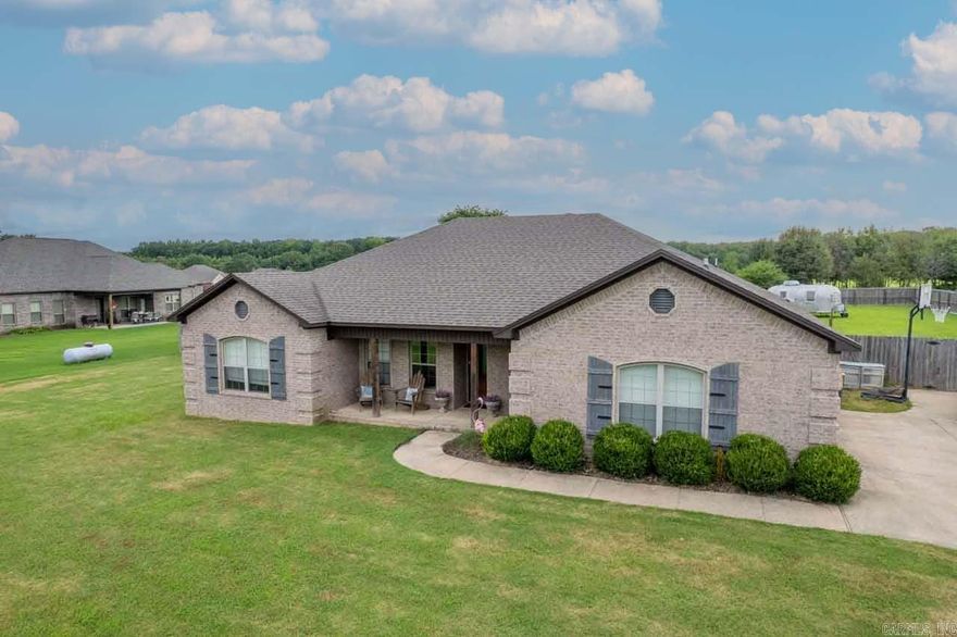 Sitting on an acre, this beautiful home has granite countertops throughout with a  spacious master suit with separate jetted tub and tiled shower. French doors in the open concept living area lead to a covered porch in fully fenced, large backyard. Patio area access from the master suite as well. Sit on your covered front porch and enjoy the pond and tons of wildlife. Mud room area off of garage perfect for backpacks and shoes. Walk in storm shelter in garage for added protection. This property has it all!