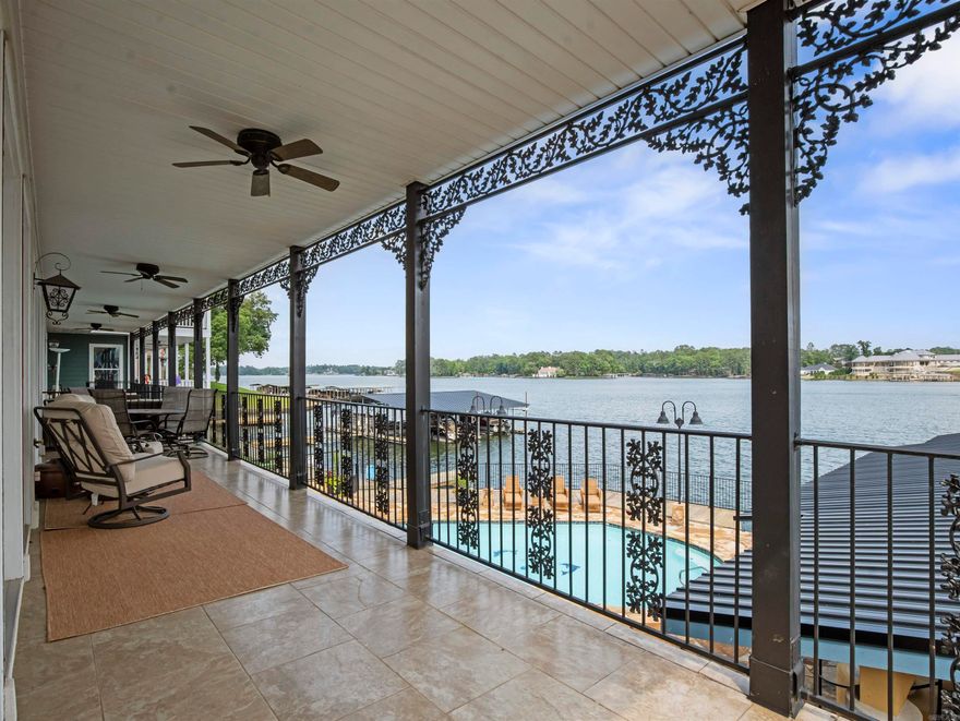 Luxury meets lake life in this 2 bedroom, 2 bath condo on Lake Hamilton possibly  the crown jewel of Fiesta Bay.  This end-unit stunner offers 1,662 sqft, of thoughtfully designed space, crafted with timeless attention to detail.  Take the elevator straight to your second-floor retreat, no stairs, no hassle where the moment you step inside, the lake steals the show. Enjoy sweeping water views from  a spacious wraparound balcony perfect for soaking in sunrises & sunsets.  This condo includes a covered boat dock equipped with a hydraulic lift, offering instant access to the lake for weekend cruising or spontaneous evening rides. Inside, you'll find Jenn-Air stainless appliances and an open concept layout.  Just a few steps,  or short boat ride, puts you at lakeside dining at Fisherman's Wharf. As part of a gated community, you'll also enjoy access to a pool and a beautifully designed outdoor kitchen and grilling area. Opportunities like this are rare, schedule your private showing today!