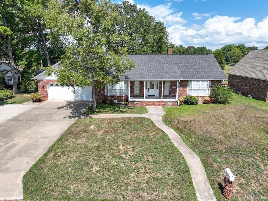 Beautifully designed and spacious, this 4-bedroom, 2.5-bath home offers comfort, style, and convenience. The living room boasts vaulted ceilings, a wood-burning fireplace, and stylish built-in shelving. Interior updates include fresh paint, new flooring throughout, and a 2022 HVAC system. The kitchen features stainless steel appliances, granite countertops, and refreshed cabinets with shaker-style doors and modern hardware. Enjoy the expansive primary suite with french doors opening to the back deck, primary bath offers a walk-in closet, double vanity, soaking tub, and a walk-in tile shower. Step outside to a large wraparound deck overlooking peaceful pastureland. With a garage big enough for lake toys and an extra parking pad, there's plenty of space for all your gear. Ideally located near shopping, restaurants, and Greers Ferry Lake access. Agents see remarks.