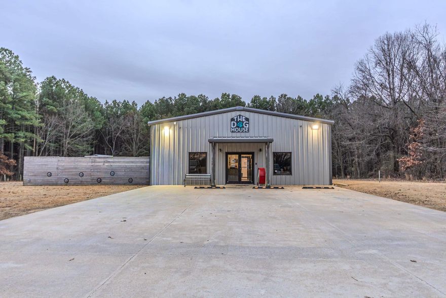 Income-Producing Commercial Property on 1 Acre. This 4,000± sq ft commercial facility is currently operating as a successful dog boarding and grooming business and offers a well-designed layout with strong functionality and expansion potential. The interior features a lobby, 40 kennel units, dedicated cat room, grooming room, additional storage/grooming rooms, kitchen, 3 bathrooms, 2 laundry rooms, garage door bay, and on-demand water heaters. The property is designed to support high-capacity operations with efficient workflow. Exterior improvements include 6 outdoor dog runs and a fenced, covered outdoor area. A separate 30x40 shop building offers two 12x12 rooms and a loft, providing additional flexibility for storage, office space, or future use. Situated on 2 acres, this property allows room for expansion and adaptability. Ideal for investors or owner-operators seeking a turnkey commercial asset in a growing industry.