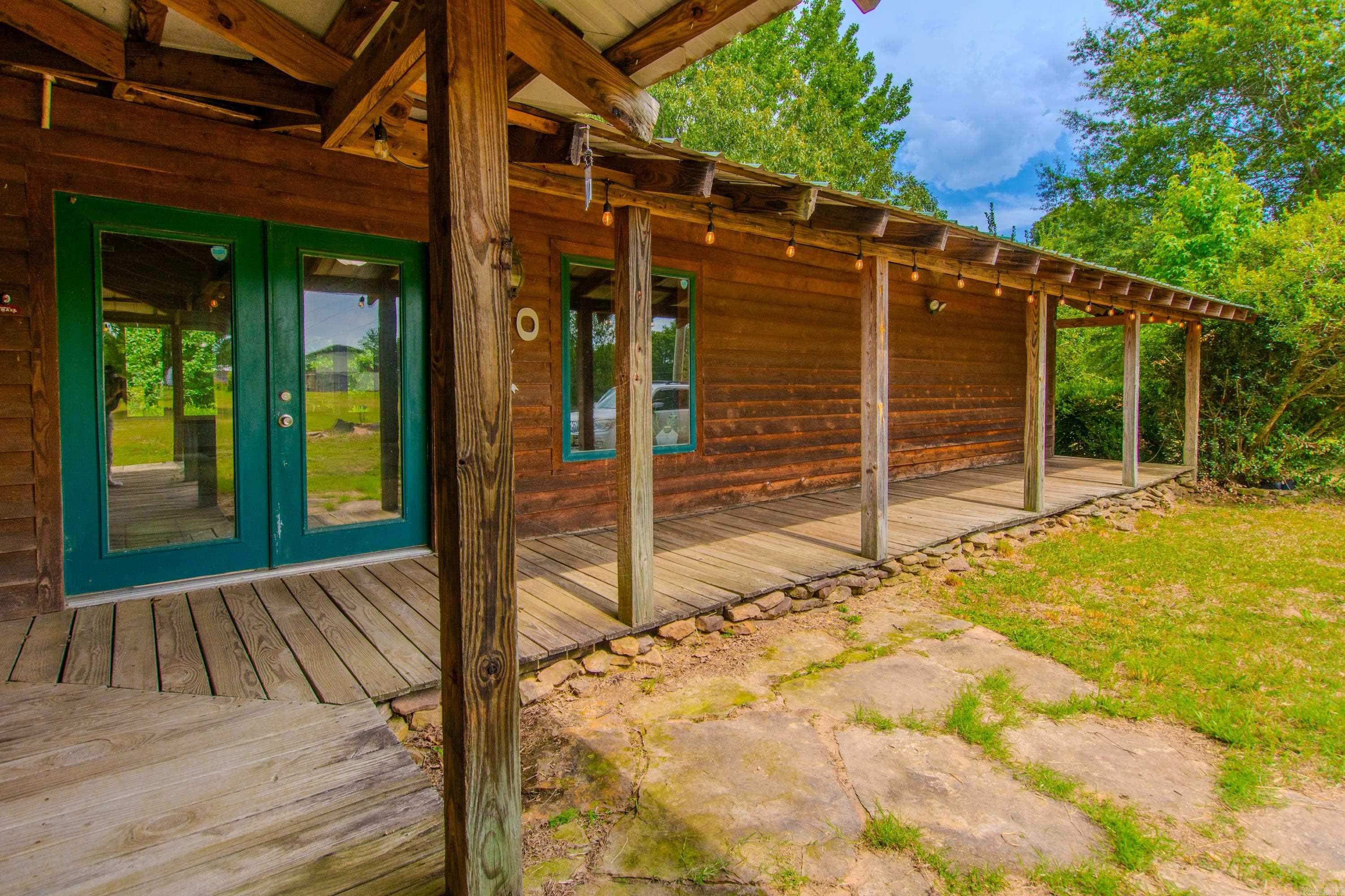 $10,000 Buyer Bonus! Use it to decorate or add another outbuilding or buy down your interest rate — the choice is yours! Create Your Dream Homestead on 9 Acres with a Pond, Privacy & Endless Possibilities! This 5-bed, 2-bath home is tucked away among mature shade trees, offering the perfect blend of space, serenity, and potential. Whether you’re dreaming of starting a farm, raising animals, growing your own food, or just enjoying a more intentional lifestyle, this property is your opportunity to make it happen! Here’s what you’ll love: 9 Acres of Usable Land — Ideal for barns, gardens, livestock; Picturesque Pond — A peaceful water feature that adds charm and character; Wraparound Porch + Upstairs Balcony — Perfect for morning coffee or evening sunsets; Practical Perks — Two covered wood sheds, a storage building/workshop, RV hookup, and a HUGE pantry; Bonus Inclusions — Refrigerator, washer, and dryer convey; Room to Expand — Plenty of space to customize and create your dream setup! Bring your vision — the land, the location, and the lifestyle are ready for YOU! Inspections welcome; home is being sold as-is. Virtual staging photos by Heather Clark. Agents see remarks.