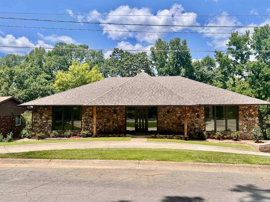 Lakefront living at its finest! This beautiful 4BR, 3.5BA, 4,111 square foot home spans two stories with two spacious living areas and spectacular views of Lake No. 2! The den has vaulted ceilings with wooden beams and a cozy woodburning fireplace and a very special bar area! Roof, flooring, siding, decks and landscaping all new this year! New paint throughout the home and all bathrooms have updates as well!  There is ample storage throughout the home and it even has two laundry chutes! There is a two car covered carport in the back of the home, with room to park many more cars, as well as a circle drive in the front of the home. There is also a saferoom! Home sits on a quiet cul-de-sac and is close to all amenities. Must see to appreciate all this home has to offer!