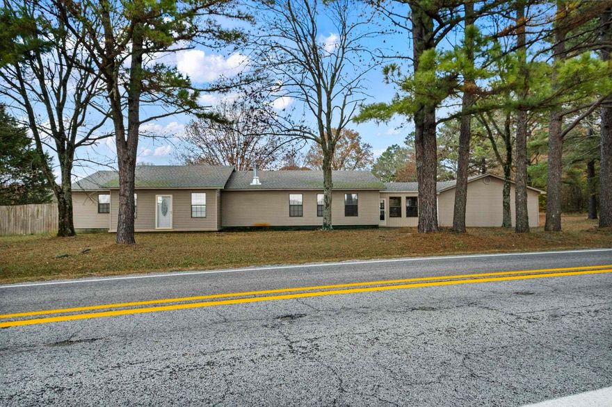 This spacious one level home offers 2265 sq ft with large open living spaces and great flexibility for every day living. It features 3 bedrooms, 2 bathrooms, a second living area, and a small office space that could serve multiple uses. The updated kitchen includes Alderwood cabinets, quartz countertops, stainless appliances-refrigerator conveys. You'll enjoy the comfort of a wood-burning fireplace, an oversized two car garage, and a roof that is approximately two years old. Sitting on nearly an acre (.93 acres) outside city limits, the property also includes two shops – a 24 x 30 and a 12 x 24 with lean-to both with concrete floors and electric.  Conveniently located just minutes from Searcy, Kensett and Judsonia, this home offers space functionality, and a great setting close to town. Taxes are after homestead credit.