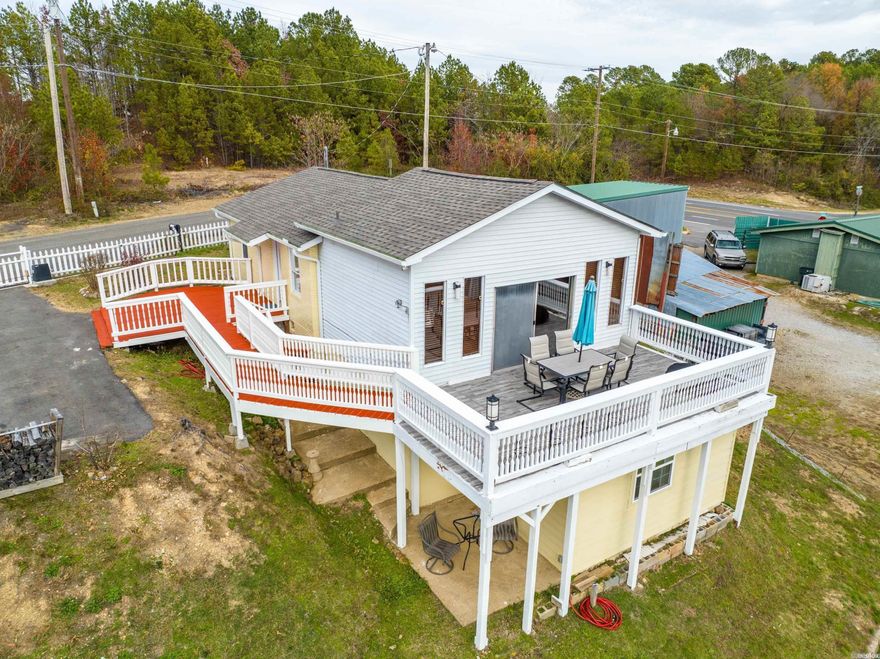 Discover this beautiful, centrally located lake house offering stunning views and unbeatable convenience. Nestled just off 7 South and in a quiet cove on the main channel of Lake Hamilton, this home provides quick access to shopping, dining, and entertainment—all within minutes.  Featuring 3 bedrooms and 2 bathrooms, this inviting property is perfect as a peaceful full-time residence or a relaxing summer getaway. The main level offers 1 bedroom, a very spacious living area and kitchen/dining. The lower level occupies two bedroom, a full bathroom and private access to outside. Don't forget the large deck where you will enjoy evening grilling or morning sunrises with coffee. Another great feature of this property is the abundance of mature fruit trees. You’ll enjoy pears, peaches, yellow apples, figs, pomegranates, blueberries, Asian dates, and Asian persimmons—right in your own backyard. This home has it all the tranquil lake views, easy water access, and the best of lakefront living in one of the most desirable areas on Lake Hamilton.