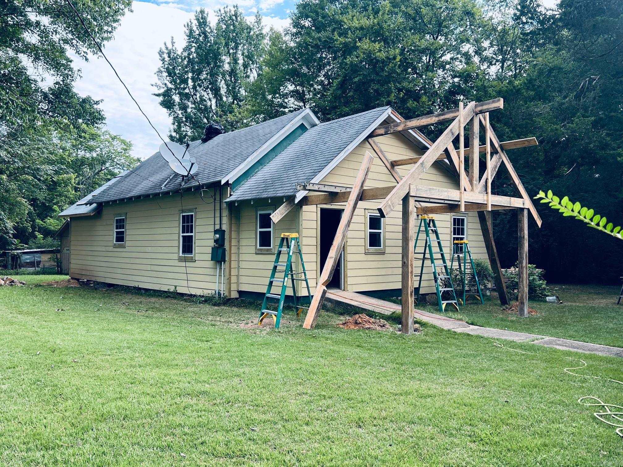 Make this home your own! New siding, new windows, new insulation, new floor joists, new subflooring, nice arched covered porch currently being added, roof is fixing to be replaced. Complete renovation in process. Property can be purchased "As Is" or owner will finish remodel to buyers wishes, colors, fixtures, flooring. Price of home will increase as remodel continues. Home is nestled on a beautiful 1.194 acres with large scattered trees in Mena city limits. There is a nice shop/storage building that could easily be converted into a guest tiny house. Beautiful land allowing room to build another home on property. Close to medical center, shopping, post office, Ouachita mountains, public swimming pool, Wolf Pen Gap trailheads, Bike trails.