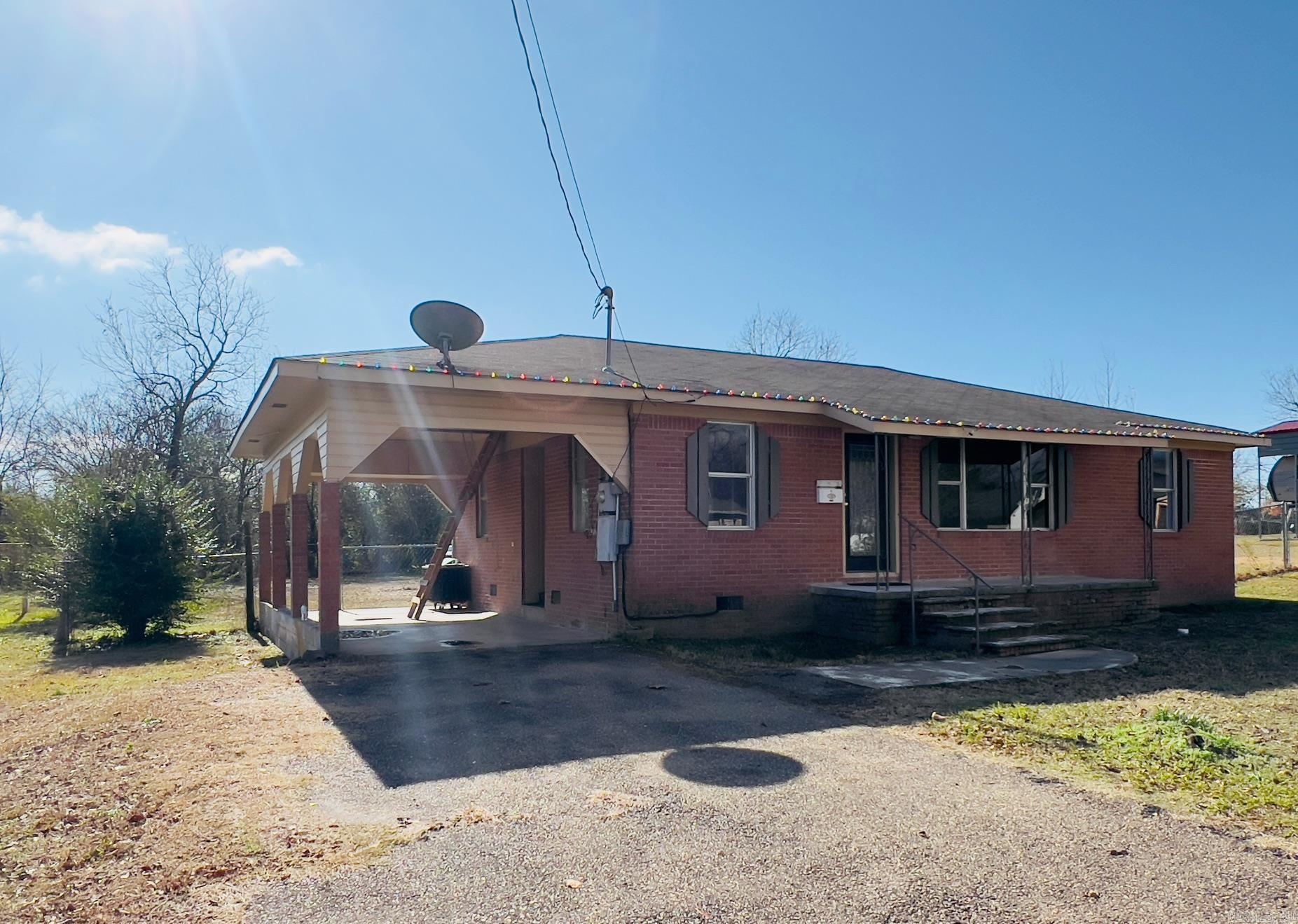 Home is livable but considered a fixer upper. Home can be purchased "As Is" or owner can remodel for an additional fee.  Home is nestled on a beautiful 1.194 acres with large scattered trees.  There is a nice portable shop/storage building that could easily be converted into a guest tiny house. There is another storage building on property.  Close to medical center, shopping, post office, Ouachita mountains, public swimming pool.