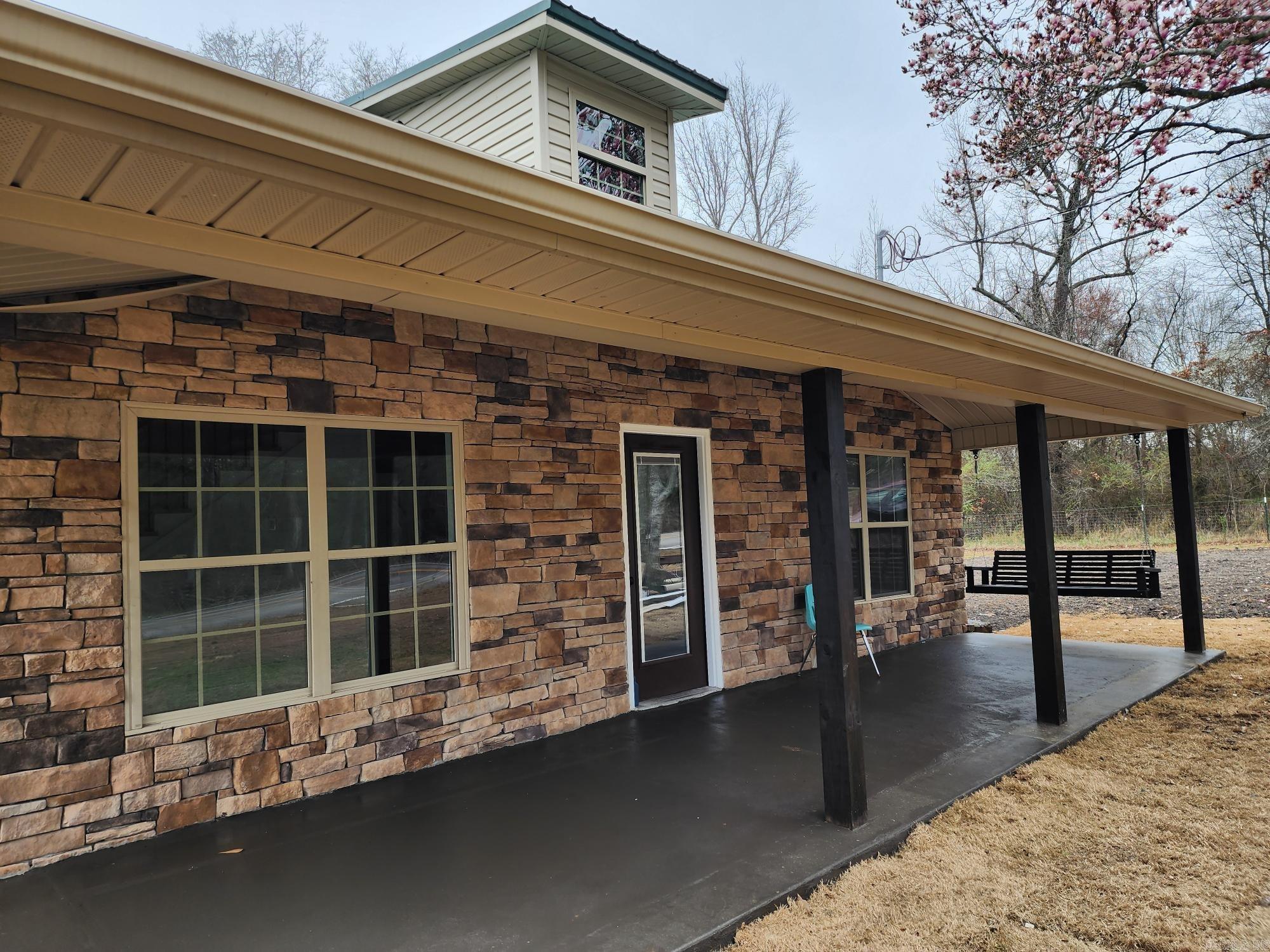 Recently totally remodeled farmhouse with large front porch is located just outside Judsonia & only 5 minutes away from Searcy. Two large bedrooms & a full bath with 10' ceilings was added to back & a 4th bedroom (bonus room) & a bath was added upstairs. The 3 bedrooms & & 2 & 1/2 baths with separate laundry, open living, dining & kitchen are all located on first floor. All counter tops are quartz, includes all new stainless appliances including refrigerator. The island 3.5x 5 island has extra storage, bar & electric. NEW CABINETS, LUXURY VINYL FLOORING, STAINLESS APPLIANCES, HVAC, WOOD STAIRCASE, STAINED WOOD BEAMS, VINYL WINDOWS, SHEETROCK, TRIM & PAINT, ELECRRICAL & PLUMBING. See agent remarks.