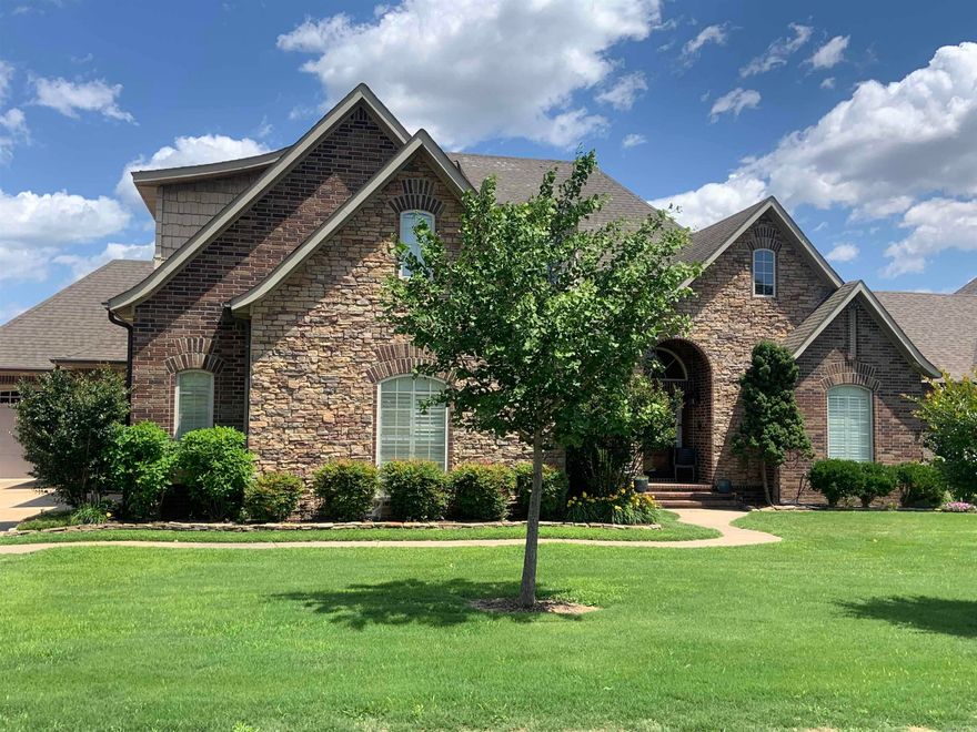 Beautiful Custom built house, all brick, 5 brs, 4 baths, Upstairs bedroom could  be an office or bonus room.  Formal Dining, Greatroom w/volume ceiling.  gas log fireplace. beautiful wide crown molding and other detailed trims.  Hardwood through out except kitchen and baths which are tile. Kitchen has cherry finish cabinets with solid surface counters, breakfast bar and breakfast room. Split floor plan.  Primary bedroom w/boxed ceiling, bath with whirlpool tub and sep shower. Two separate vanities. Covered back porch with phantom screens and a rock patio and fire pit. Beautiful landscaping and privacy fenced.   Double garage and a single garage.     .