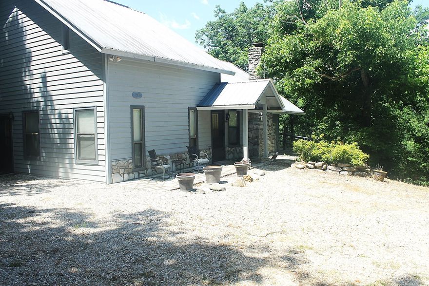 Perched Above the Sylamore, is a serene mountain retreat nestled on 3.22 wooded acres high above the Sylamore River. Tucked deep in the heart of the Ozarks, this rustic 1800 sqft, 3-bed/2-bath home is the perfect haven for those looking to unplug and reconnect with nature. Breathe in the crisp mountain air from your front deck where the only soundtrack is the breeze through the trees and the distant song of the Sylamore river. With its traditional wood exterior, metal roof, and vaulted ceilings, the home blends beautifully into its natural surroundings. The first-level has main bedroom with full bath access across hall for convenience, while the upstairs features 2 addt'l bedrooms and full bath for guests or family. A cozy living area with wooded views invites warm fires and quiet mornings. The kitchen is equipped with stainless steel appliances and flows easily into a dedicated dining space, perfect for sharing meals after a day of adventure. The 1-car garage & workshop are ready for your hobbies, kayaks, or gear. When you're ready to explore, you're just minutes from the White River, Blanchard Springs Caverns, and Mountain View—home to live music, local art, and southern charm.