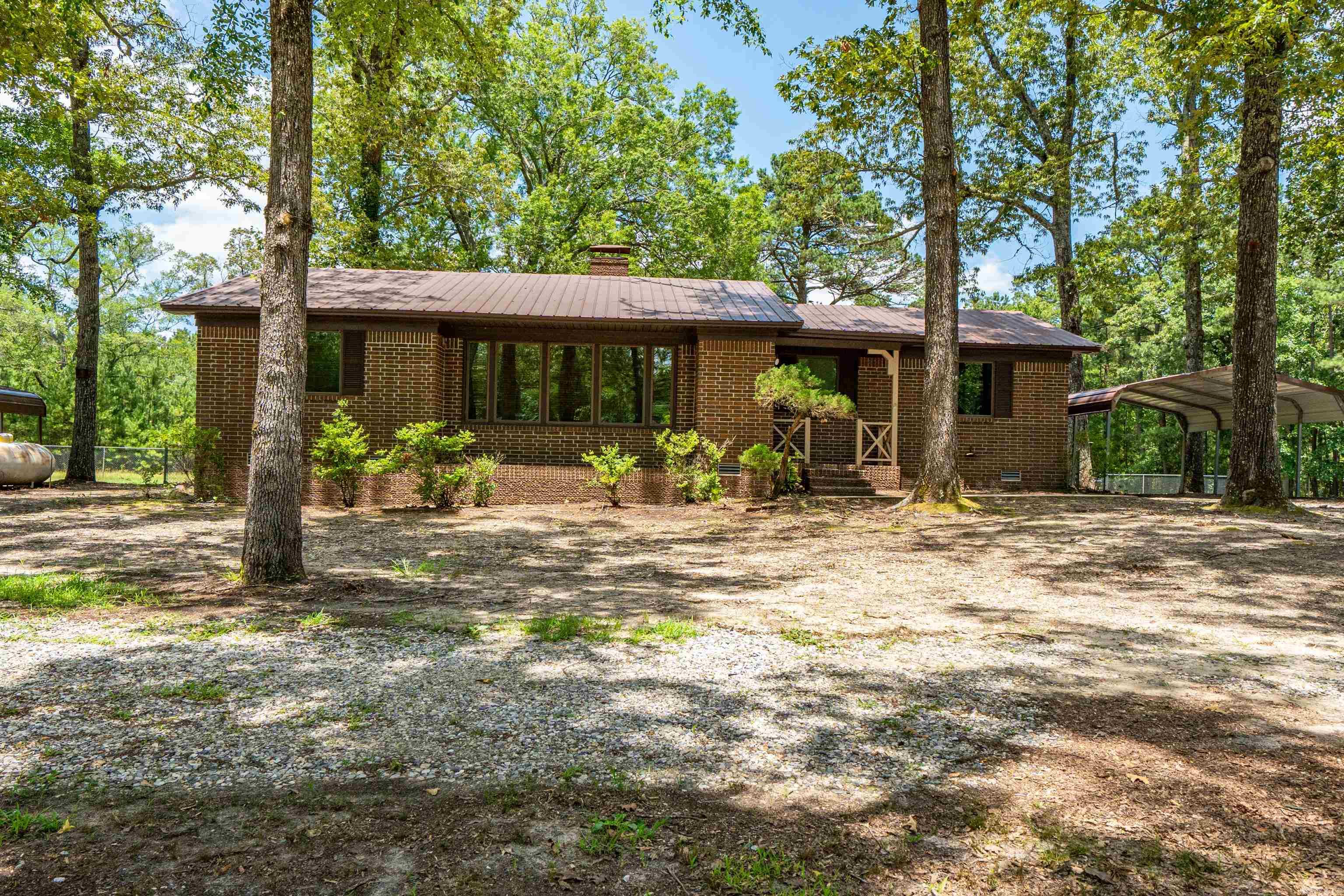 Solid 3 bed, 2 bath brick home on 5.5 acres that is fully fenced!! Just outside of Malvern on Highway 270. Over 1400 square feet with a great back porch overlooking the wooded property line. Get ready to see deer! This property offers a large building for storage and also a rustic barn...your own peaceful, county retreat! Inside you'll enjoy the split floor plan and the roomy primary sweet. In the winter you can cozy up to the real wood fireplace!! This home has been maintained regularly through the years. Some of the items: metal roof was serviced a year ago and only 12 years old! The heat was replaced 10 years ago and the air conditioning 8 years ago. The hot water heater was replaced 2025 with an on demand! There is a vapor barrier under the house and added blown in insulation in the attic. Don't miss this one!