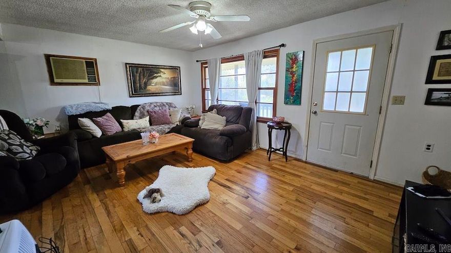 This cozy and spacious home is situated on a level, approximately 1-acre lot with towering oak trees, offering both shade and charm. Located on a paved road just minutes from Oxford and 12.5 miles from Melbourne, AR, it’s perfect for families seeking a quiet, country setting with convenient access to town. A covered front porch provides a great space to relax while watching kids play in the expansive yard. The property includes a carport with a side entrance into the laundry/mudroom for easy cleanup. Inside, the living room features beautiful real oak hardwood flooring and a large front window for natural light. The kitchen boasts oak cabinets and is open to the dining area, making it ideal for entertaining. There are three generously sized bedrooms and one full bathroom with a shower/tub combo and a large vanity. An addition at the rear of the home is fully framed and prepped for a massive primary suite with stubbed-out plumbing—ready for your finishing touches. The property could also be combined with an adjacent 170-acre farm currently for sale. Priced to sell and move-in ready, this home offers space, charm, and potential. Schedule your private showing today!