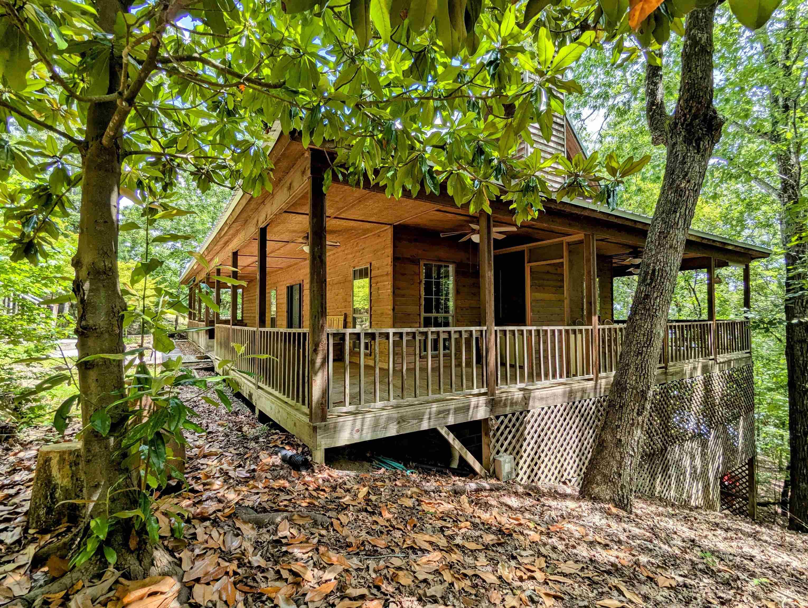 Charming Lakefront Home on Greers Ferry Lake! This three bedroom cabin features a wrap around porch, lots of glass, large decks, easy walk to the water, bonus bunk closet, and very good privacy. Lots to love here!