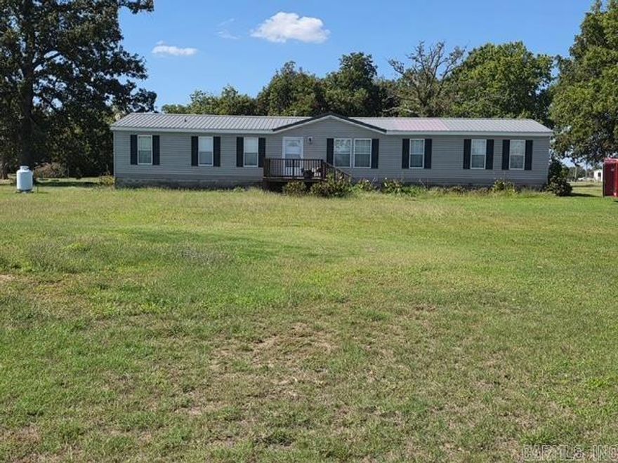 GREAT LOCATION!  Spacious home on 2.8 acres – just 1 mile from the city limits. Enjoy the perfect blend of country privacy and city convenience with this 2,160 sq ft manufactured home set on 2.8 acres. Inside, you’ll find 4 bedrooms and 2 full baths, including a private master suite with a cozy sitting area, large walk-in closet, and a generous master bath.  Also features a den with a wood-burning fireplace. Eat in kitchen with lots of cabinet storage. Brand new central heat and air in August 2025, plus a propane hookup with a 100-gallon filled tank ready to go. Metal roof.  All appliances—including washer and dryer stay with the home.  City utilities and septic.