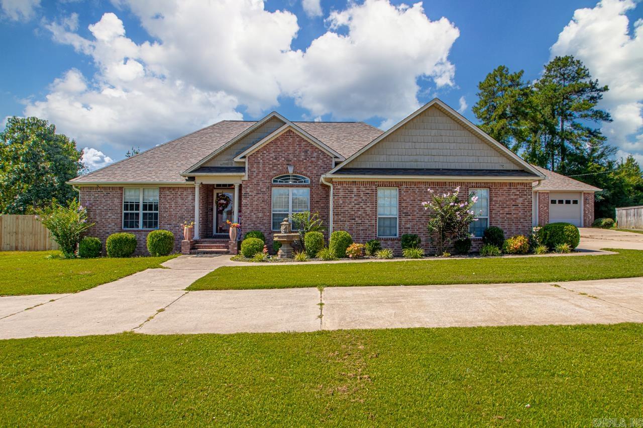 Discover comfort, space, and convenience with this beautifully maintained all brick home situated on 3.45 private acres. Step inside to a spacious layout featuring granite countertops, his and her master closets, and a wood burning fireplace. If you're looking to entertain, this home has an enclosed sunroom that is perfect for upcoming football watch parties. Enjoy peace of mind with a whole home security system and 12-person storm shelter. Outdoors, enjoy a new backyard fence, your very own backyard putting green and a 40x30 shop that matches the exterior of the home. The shop also has electricity and a mini split so if you work from home, this would be perfect for you! If you need additional covered storage, there is a lean to behind the shop. Don't miss your chance to own this incredible property that combines rural charm with modern amenities-all just a short drive from town!