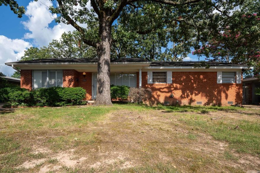 Charming and move in ready in the highly sought after Park Hill area of North Little Rock! This updated one level home offers 3 bedrooms, 2 full bathrooms, multiple living spaces, and a flexible layout that gives you room to spread out. Inside you’ll find original hardwood floors, fresh paint, granite countertops, and a mix of modern updates with timeless character.  The spacious bonus room makes a perfect second living area, game room, home office, or playroom, while the sunroom provides a bright and relaxing space overlooking the backyard. Outside, enjoy a fenced yard, covered parking, and additional storage or workshop space.  Conveniently located near downtown North Little Rock, shopping, restaurants, parks, and schools, this home offers both comfort and convenience in an established neighborhood. Qualifies for 100% financing for eligible buyers. Come see everything this Park Hill home has to offer!