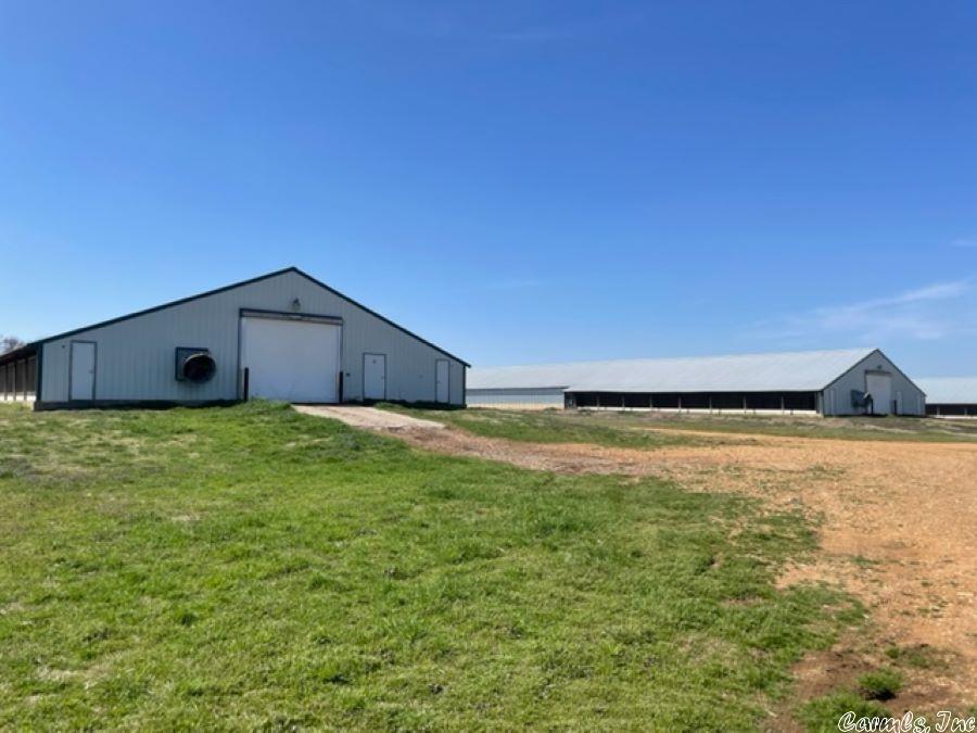 6 house broiler farm (appx. 118,000 sq.ft) w/Tyson contract. Very well maintained houses and equipment that is performing very well. The farm includes 40 +/- acres of fenced pasture land w/ large barn, working coral, cross fences, 2 litter sheds, one composter, 3 wells, rural water and 2 generators. The farm comes w/shop and shop house w/living quarters of approximately 1,500 sq ft of living space w/2 bedrooms. The shop is approximately 1,290 sq ft and could easily be converted into more living space.
