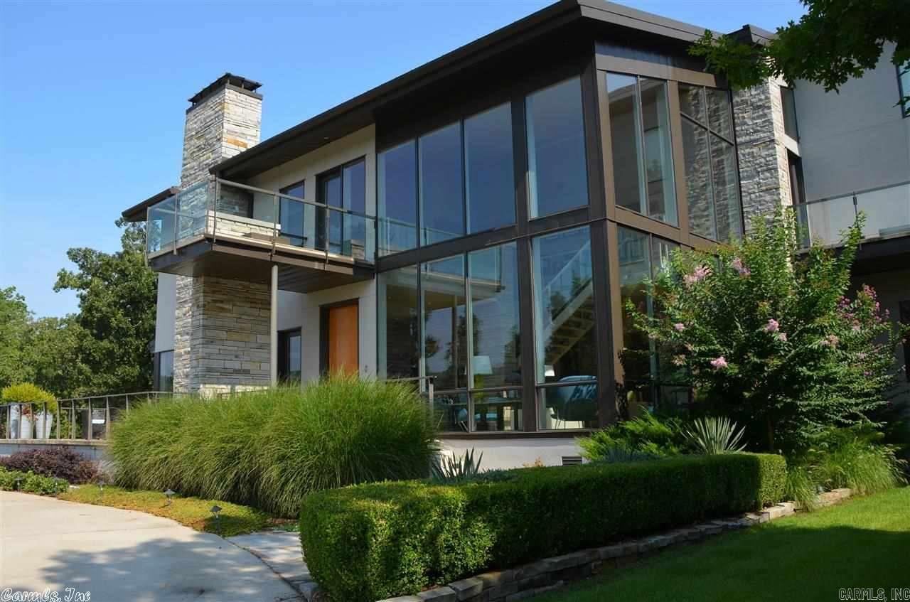 Architecturally custom designed home with spectacular views. Only minutes from Chenal and Kanis. Walls of glass, open floor plan, beautifully appointed living areas, kitchen with every amenity. Master Bedroom has sitting area with view. Numerous outdoor living areas, lovely landscaped yard. Circle drive, beautiful woods, open pasture along the little Maumelle River. Separate building containing enclosed parking, heated and cooled large office, workshop and full bath. Gated Privacy 24 Hour Showing Notice