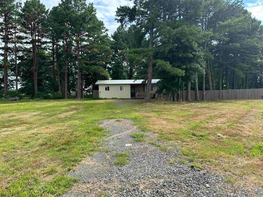 Looking for a small home to call yours? Take a look at this mobile home with 1.11 acres just outside of Hickory Plains. Has city water, septic system, fenced in yard and easy access off of Highway 38. The home is small, but it has everything you need. Kitchen area, full bathroom, bedroom, covered porch, and extra living room/storage off of the front porch.