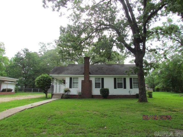 This beautiful Move-in-Ready remodeled home sitting on two lots with a total of .68 Acre with a welcoming porch is located close to schools, shopping and major employment and features formal living room with remote control light and fan, fireplace with gas logs, kitchen with dining area, two large bedrooms, and a bath with shower over the bathtub. Home has been updated with vinyl floors, new lighting and ceiling fans, painted with neutral colors, central unit, has plantation blinds, double carport, one concrete and can be used as outdoor living area. Yard has a partial fence, a storage/garage that is shared with neighbor and a storage house in the back yard. There is also a concrete slab where a storage building could be added. Make your appointment today to see this lovely home.