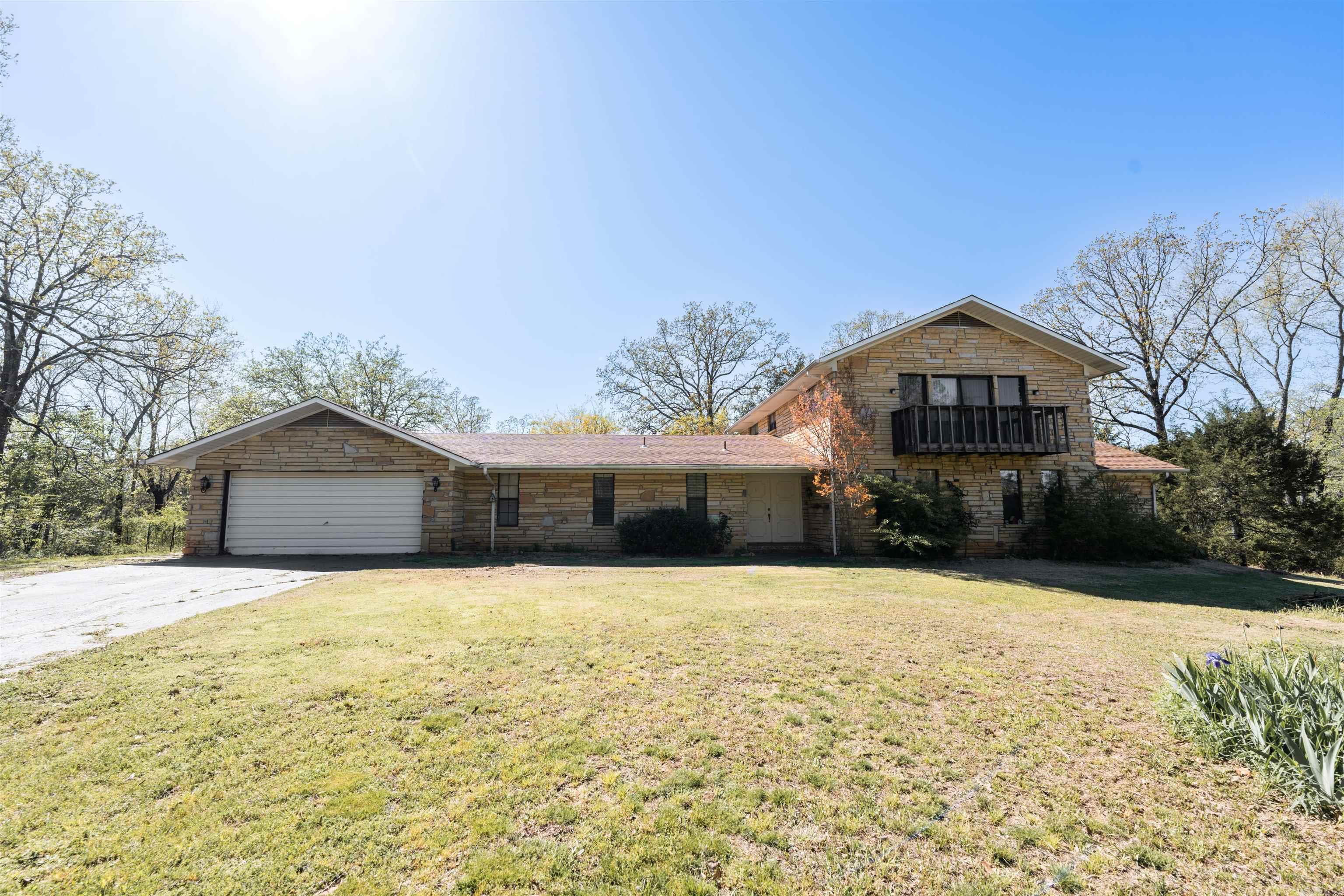 This one-owner, custom-built home offers the rare opportunity to own a peaceful retreat just outside Conway city limits. Nestled on 3.78 acres, this 3,671 sq ft home combines privacy with close-to-town convenience. Inside, you’ll find 6 spacious rooms, ideal for bedrooms, home offices, or creative spaces. With 3.5 bathrooms, comfort and functionality are a priority. The heart of the home is a large recreation room with a full wet bar, perfect for entertaining or relaxing after a busy day. The home is built with lasting value in mind, featuring timeless stone construction, a gated entry, and its own well. Out back, a 2-bay shed provides extra space for hobbies or storage. The expansive property offers plenty of room to garden, roam, or expand. Whether you’re an investor looking for a project or a homeowner seeking peace and privacy, this home offers endless potential. Make it your own and enjoy the perfect blend of seclusion and convenience.
