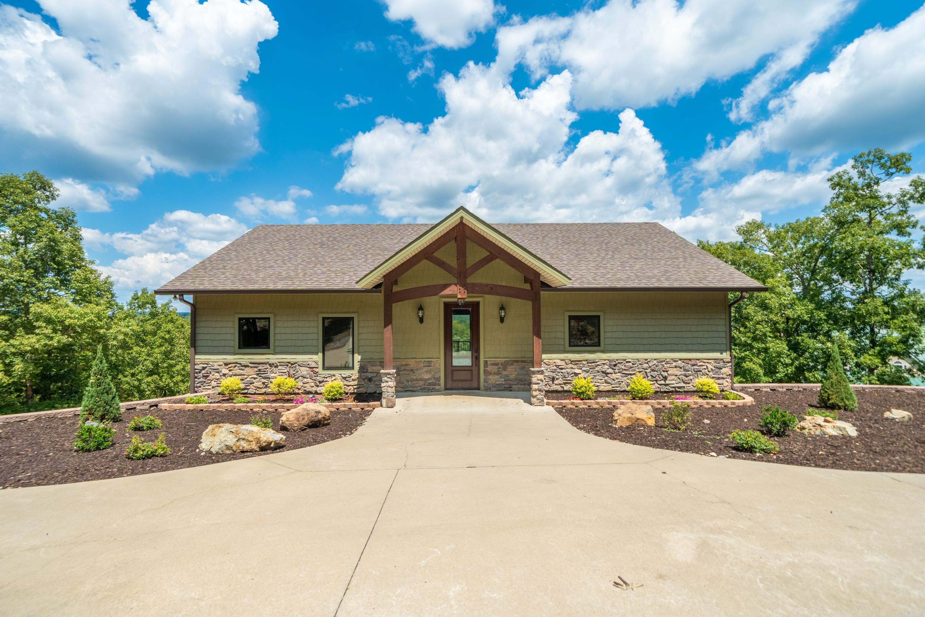 Discover exceptional craftsmanship and tranquil lakefront living in this true Douglas Fir timber frame masterpiece, nestled on over 2.5 acres along the shores of Lake Hamilton. Custom Fleur-de-Lis inspired king trusses, soaring ceilings, and a hand-laid stone fireplace crowned with a hand-hewn oak beam create a warm yet luxurious ambiance. Two spacious lofts offer flexible space for lounging or additional sleeping quarters-perfect for personal enjoyment or generating short-term rental income. Enjoy 183 ft of pristine shoreline, a backyard designed to accommodate a stunning infinity pool that would seamlessly blend into the lakefront horizon, and a previously permitted two-boat dock. The property backs to protected wetlands, ensuring unmatched privacy and breathtaking natural views. Built with energy efficiency in mind, the home features 6ā spray foam insulation throughout, Pella Proline low-E windows, and insulated garage doors. Exceptionally oversized 3-car garage has soaring 13ā ceilings with room to fit your car, full sized truck, boat, ATVs and more. Finished with Marazzi porcelain tile, this retreat offers the perfect balance of elegance, sustainability, and outdoor potential